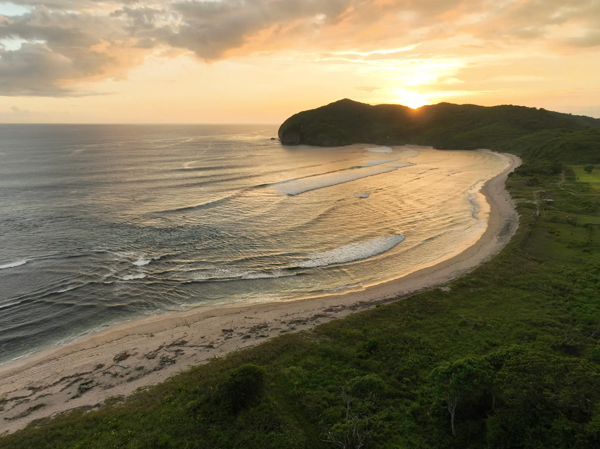 Drone view of Eco Bamboo Beach Front Lodge nestled into hillside jungle above the Indian Ocean — Kini Resort West Sumbawa