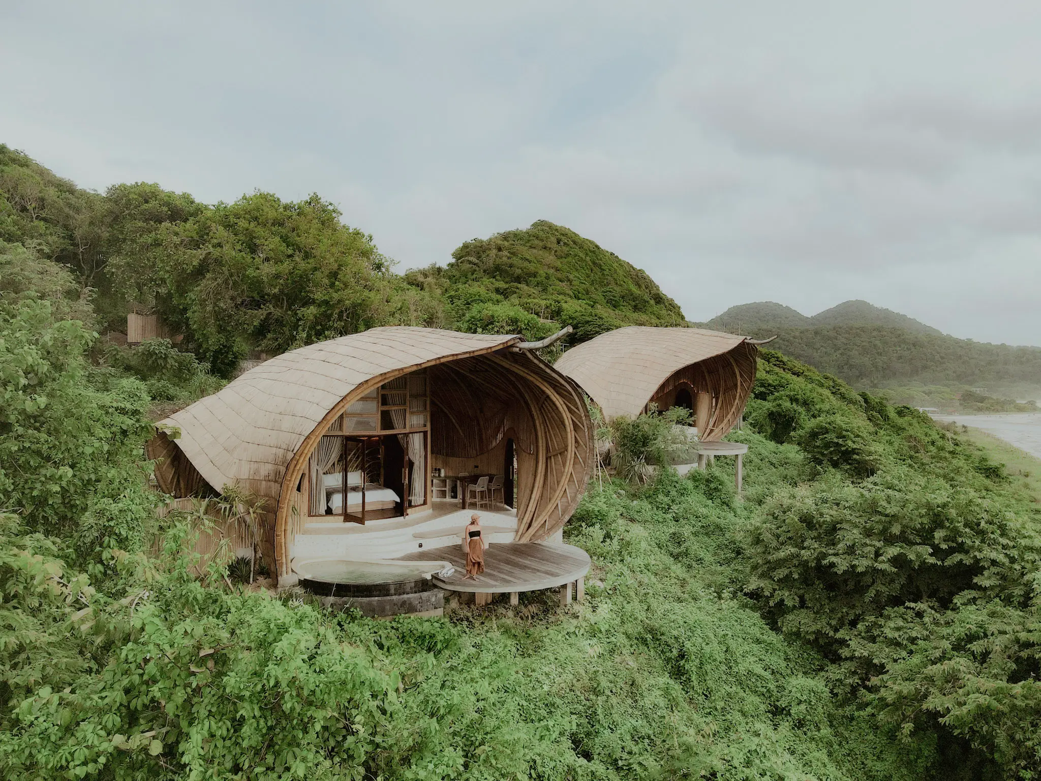 Aerial view of Eco Bamboo Beach Front Lodge at Kini Resort Sumbawa overlooking the Indian Ocean and tropical jungle